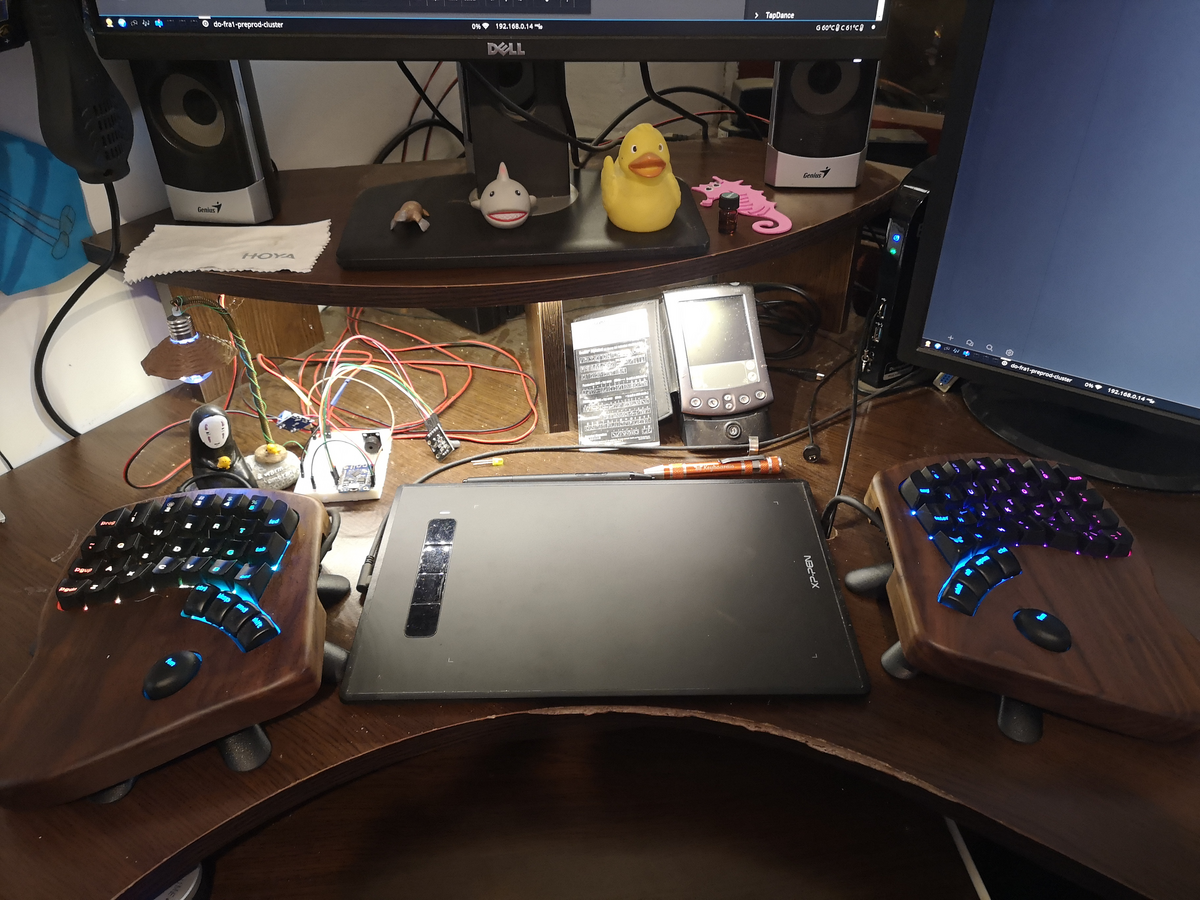 Photo of my desk, a dark brown computer desk with a monitor stand and a separate monitor next to it.